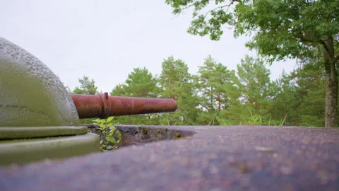 Low angle shot of a weathered green turret with a rusted barrel 스톡 동영상 305109614