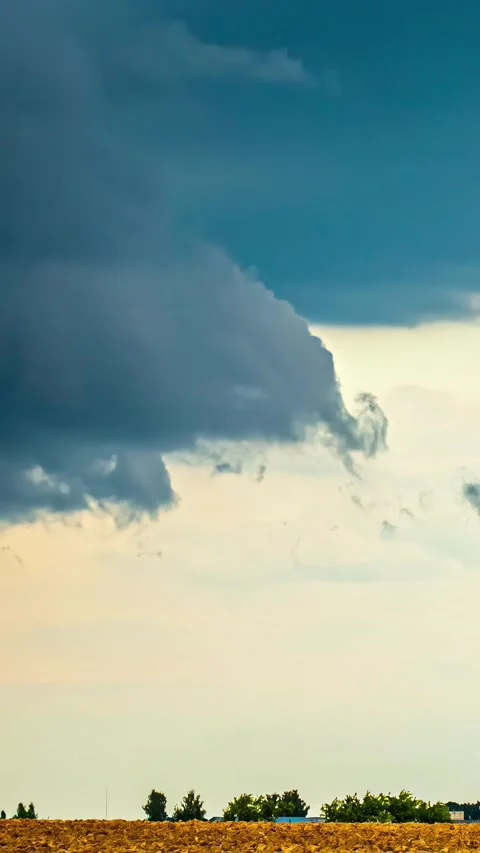 Low angle shot of white clouds bursting above a field. Timelapse. Stock Footage 305506758