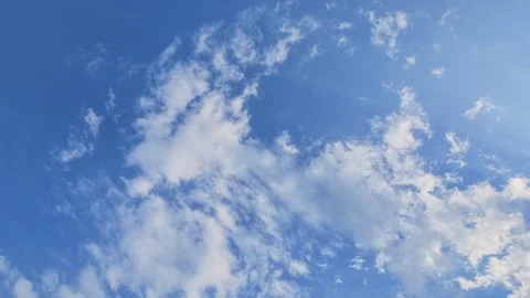 Low angle shot of white clouds moving in blue sky Stock Footage 345484931