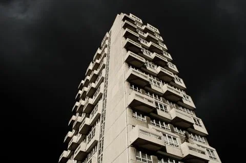 Low angle shot of a white high-rise building under the dark night sky Stock Photos