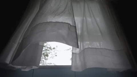 Low-angle shot of white transparent curtain fabric blowing, rainy day Vídeos de archivo 315078441