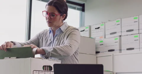 Low angle shot of a woman sorting through boxes of files. Stock Footage 138665000