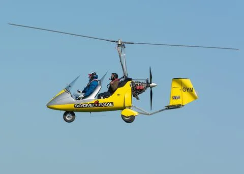 Low angle shot of a yellow skydive jet in the air in Dubai, UAE Stock Photos
