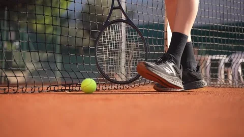 Low angle shot of a young boy takes the tennis racket from the net. Stock Footage 303723759