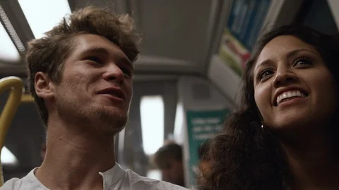 Low angle shot of a young loving couple laughing on the subway. 스톡 동영상 116011807