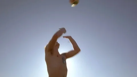 Low angle shot of young man jumping and passing a ball 스톡 동영상 73350672