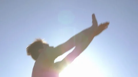 Low angle shot of young man jumping and passing a ball Stock Footage 73350702