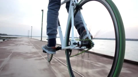 Low angle shot of young man riding sport bike near river landscape on cloudy day Stock Footage 132674012