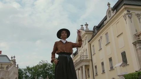 Low angle shot of young model in boho style look and trendy hat walking down the Stock Footage 94877915