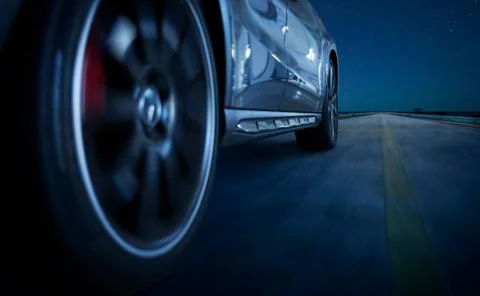 Low angle side view of car driving fast Stock Photos