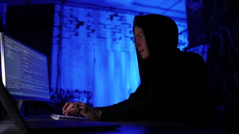 Low-angle side view of dangerous hacker man typing code on keyboard late night Stock Footage 196168154