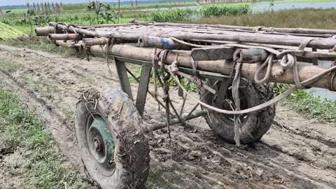 Low Angle Side View Of Empty Traditional Wooden Horse Cart On Muddy Dirt Road Stock Footage 340195972