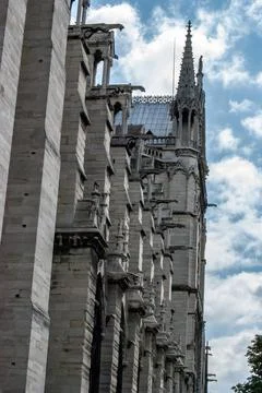 A low angle side view of the facade of Notre Dame de Paris in France against  Stock Photos