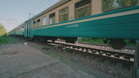 Low-Angle Side View: Passenger Commuter Train Moving Along Railroad Tracks Stock Footage 335226278