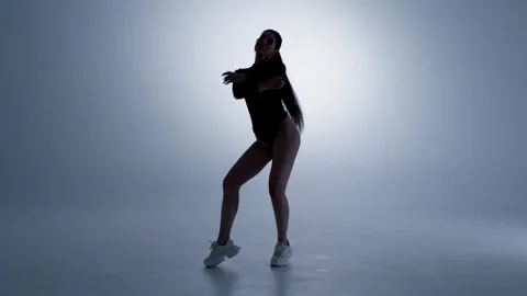Low angle silhouette of dancer performing go-go dance under strobe light 스톡 동영상 348084777