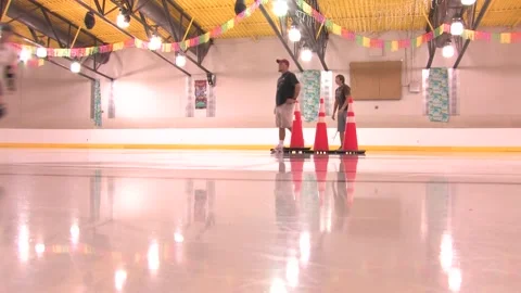 Low angle of skaters on track as coaches watch on, Texas Roller Girls Stock Footage 232957930