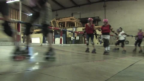 Low angle of skaters on track during training, Texas Roller Derby Video stock 232957972