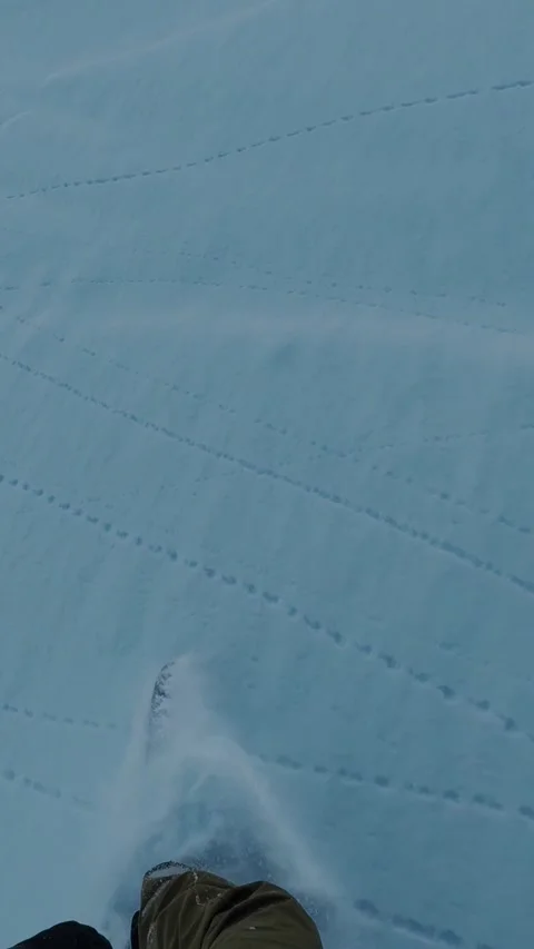 Low angle of ski tips cutting through fresh snow, vertical Vídeo Stock 325782177