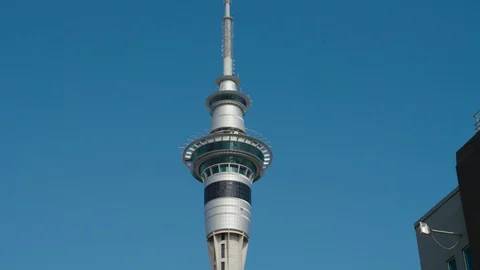Low angle Sky Tower zooming out revealed from buildings. Stock Footage 90341533