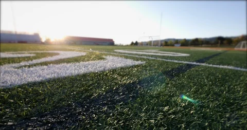 Low-angle slider camera move on a highschool football field. Stock Footage 129103182