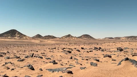 Low angle slider motion of volcanic desert plain covered with black basalt Stock Footage 340868972