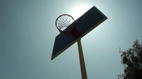 Low angle slow motion of basketball player slam dunking outdoors Stock-Footage 44019814