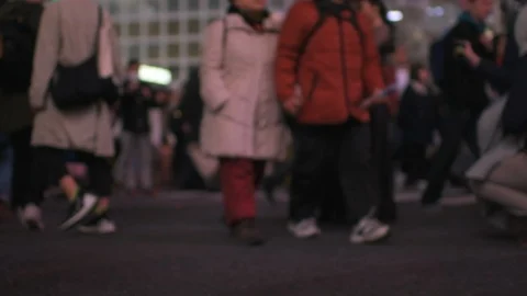 Low angle slow motion of people at Shibuya crosswalk at night in Tokyo, Japan Stock Footage 120025445