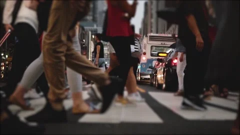 Low angle slow motion shot of people's legs and feet walking across a busy city Stock Footage 94687911