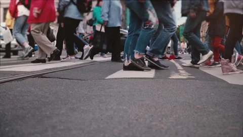 Low angle slow motion shot of people's legs and feet crossing a busy city street Stock Footage 95030098