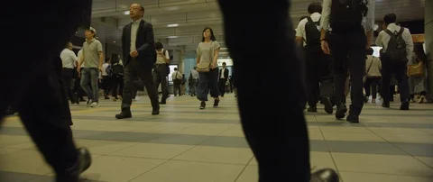 Low angle slow motion shot of people walking in tunnel to other side, Tokyo Stock Footage 136116692