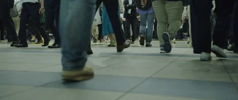 Low angle slow motion shot of people walking in tunnel to other side, Tokyo Stock Footage 136118029