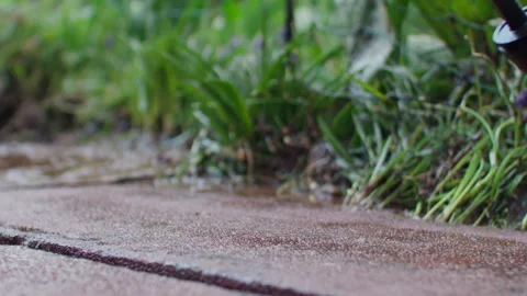 Low angle slow motion shot of cleaning a flagstone with a high pressure Vídeos de archivo 242016461