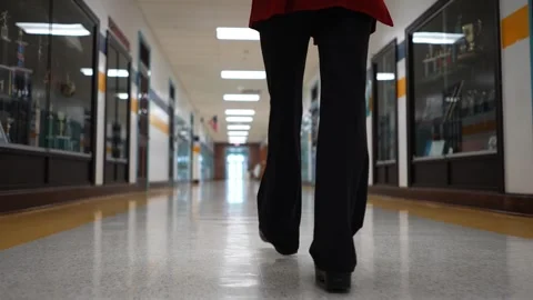 Low angle slow motion of teachers shoes walking down an empty school hallway Vídeos de archivo 245038375