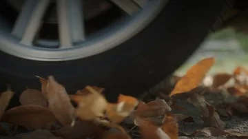 A Low Angle Slow Motion View of Car Wheels.  Close up Stock Footage 85423377