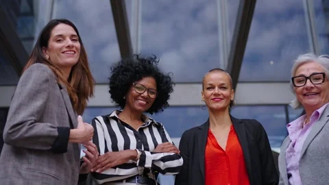 Low angle. Smiling group of diverse business women in formal suit standing side Vidéo 276510062