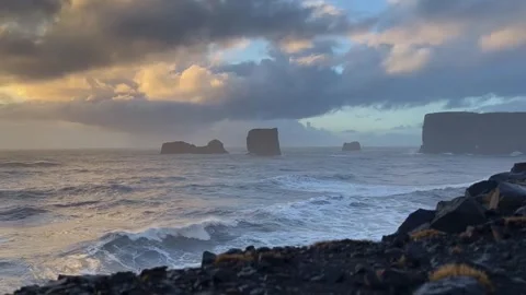 Low angle static shot of Atlantic ocean waves and sea stacks at sunset from.. Stock Footage 327683795