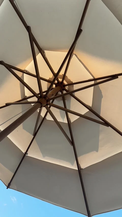 Low-angle static shot of beach umbrella structure Stock Footage 339733837