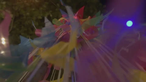 Low Angle Static Shot of Colorful Festive Ribbons and Lights at Night 스톡 동영상 332456330