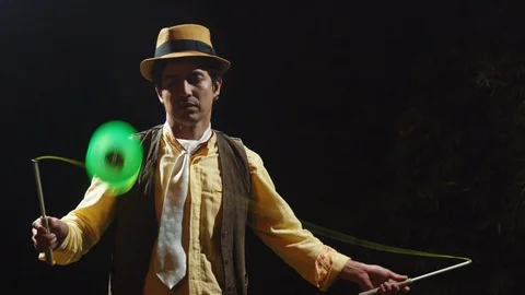 Low angle static shot of a magician performing diabolo tricks in ecuador Stock Footage 113938527