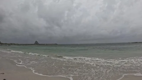 Low angle static shot of ocean waves washing white sand at Bleik Beach Norway Vidéo 343130695