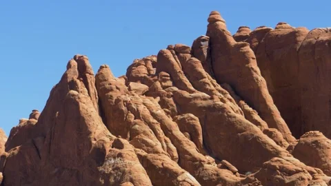 Low angle static shot of tall and jagged rock formation peaks Stock Footage 160807241