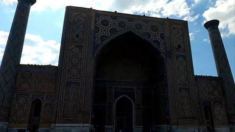 Low angle static shot of Ulugh Beg Madrasa facade in shadow Stock Footage 336894932
