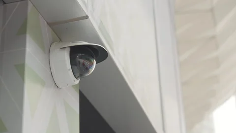 Low-angle static shot of white surveillance camera with hood Stock Footage 266144350