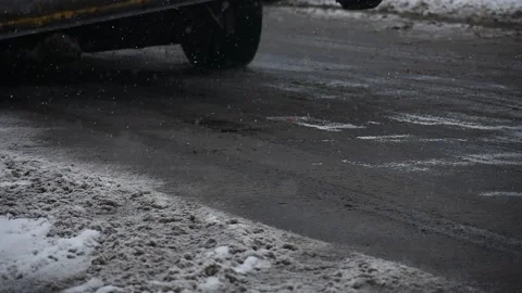 Low Angle Street Shot, Winter, Cars and Snow Plows Drive by Left to Right Stock Footage 148704376