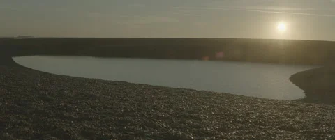 Low-angle Suffolk Shingle Beach Reflective Pool Water Morning Stock-Footage 320114645