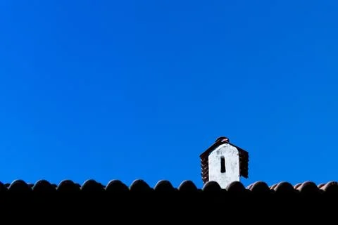 Low-angle of a sunlit white object on the roof, clear sky background Stock Photos