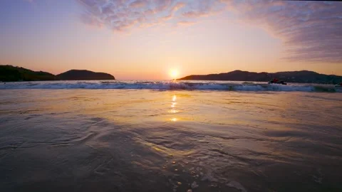 Low Angle Sunset Waves Rolling Toward Shore Video stock 330078819