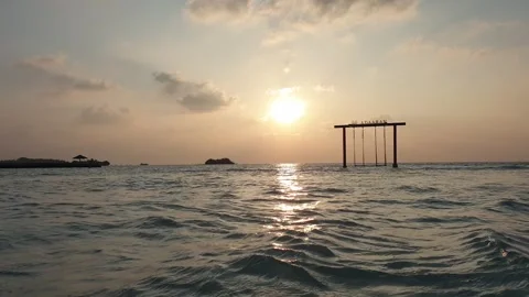 Low angle swing at dusk ocean maldives zoom in Video stock 280795125