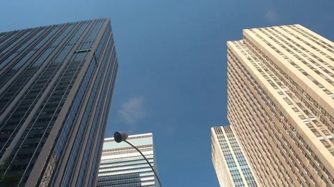 LOW ANGLE: Tall Modern glassy skyscrapers and office buildings in NYC downtown Stock Footage 72937619
