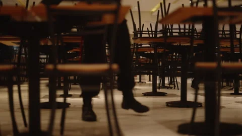 Low Angle Through Stacked Chairs in a Closed Food Court Stock Footage 340558104